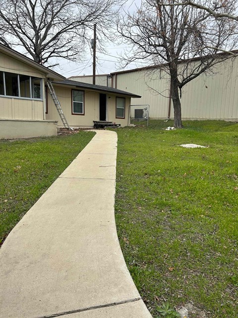 a sidewalk in front of a house
