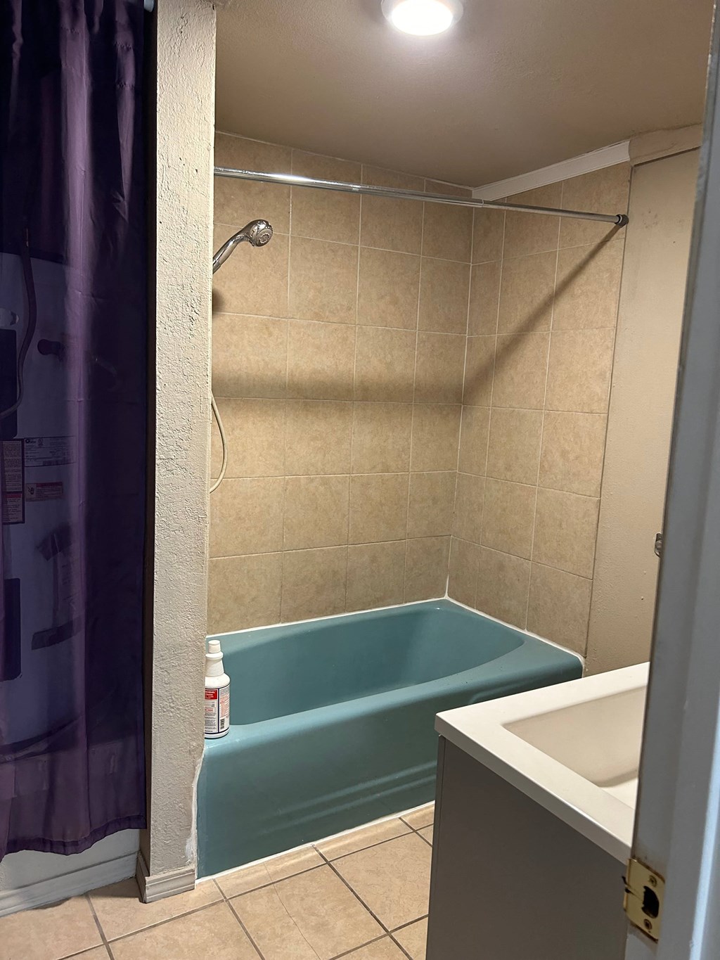 a bathroom with a tub and a shower and a sink