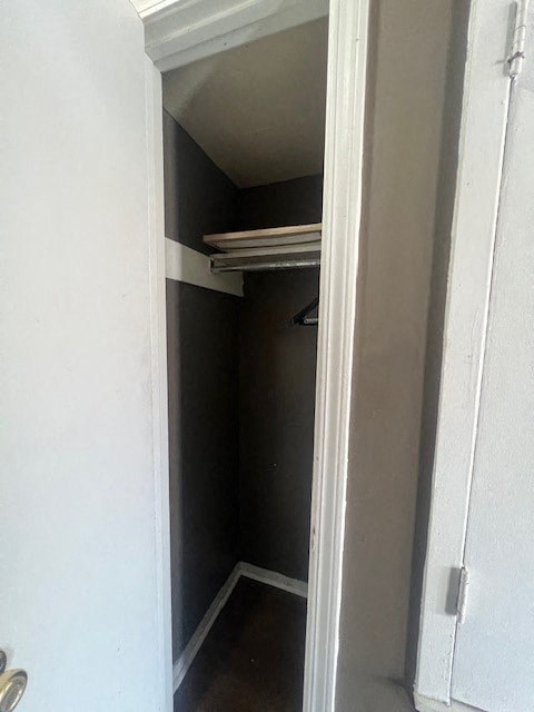 a small closet in a bathroom with a white door
