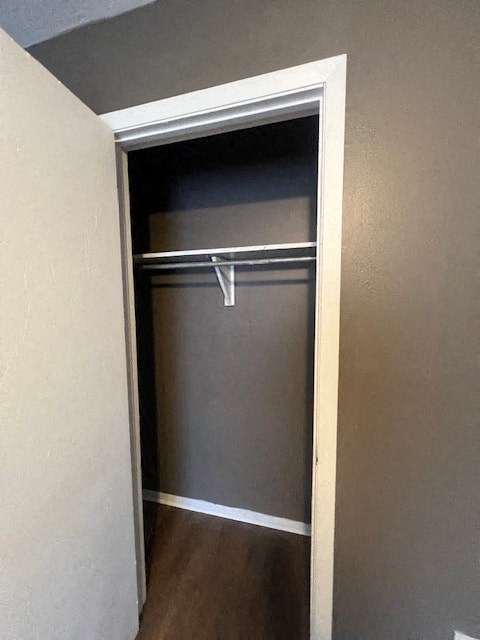 an empty closet with a door open in a room