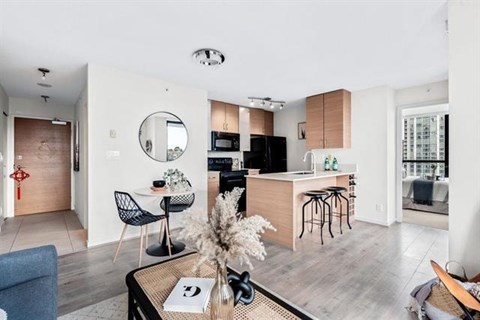 A modern kitchen with a dining table and chairs.