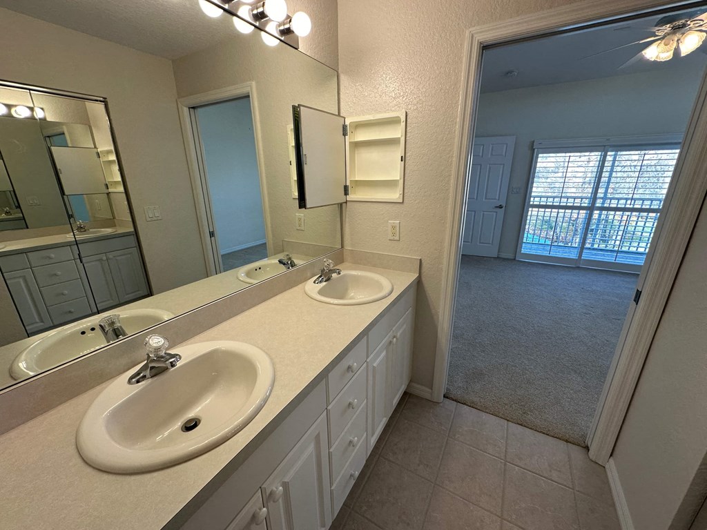 a bathroom with two sinks and a large mirror