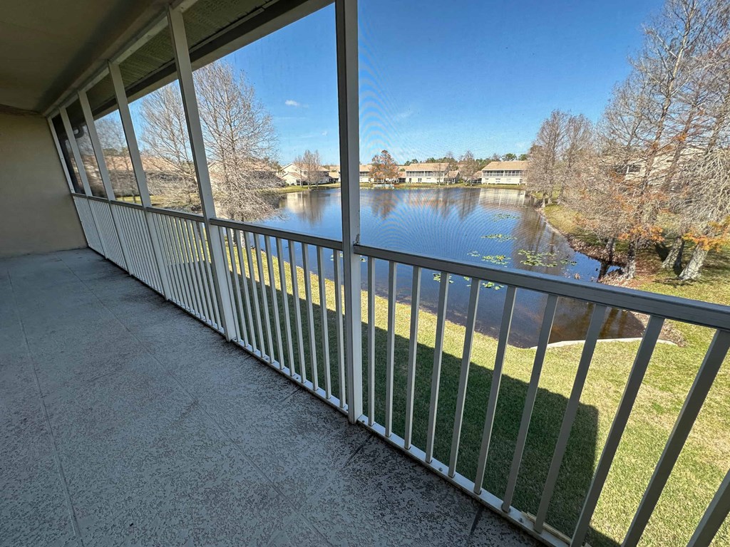 the view of the lake from the balcony of a home