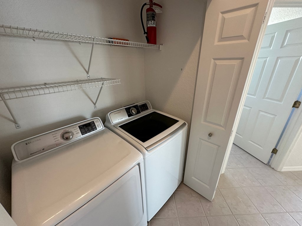 a washer and dryer in a laundry room with a closet