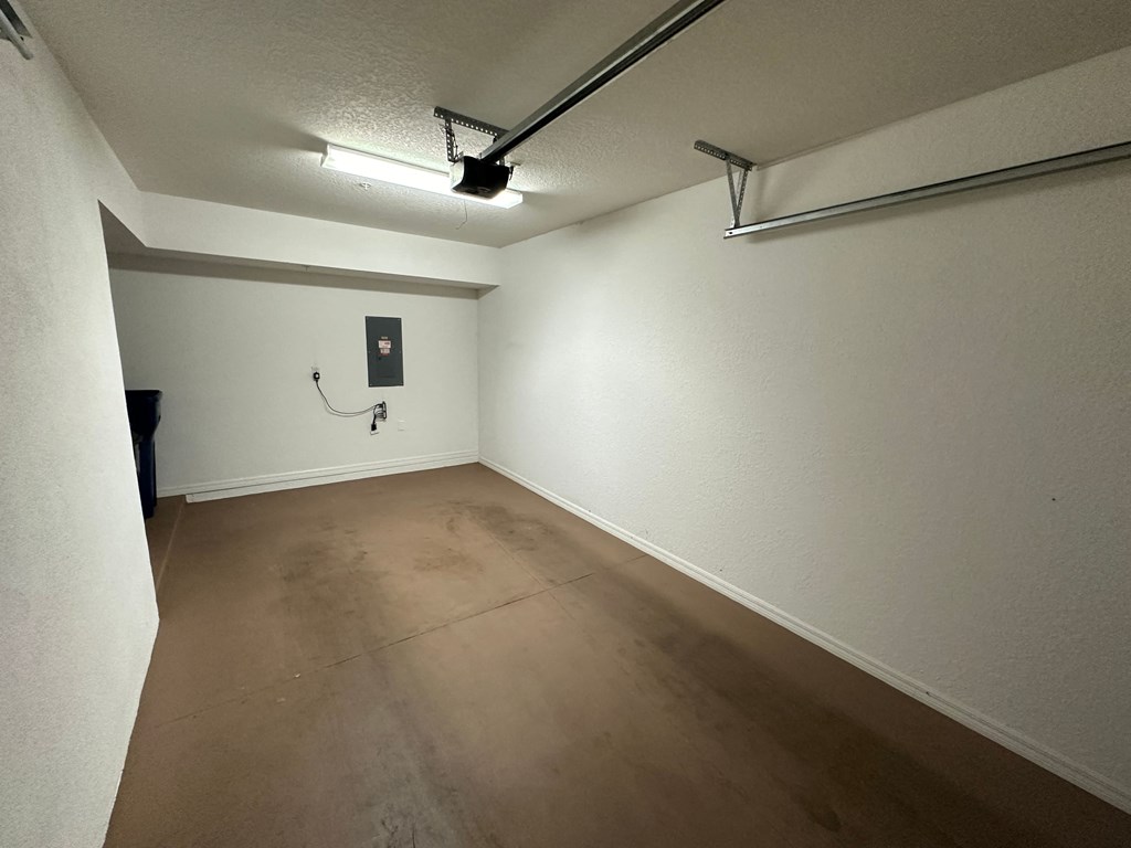 a empty room with a wooden floor and a white wall