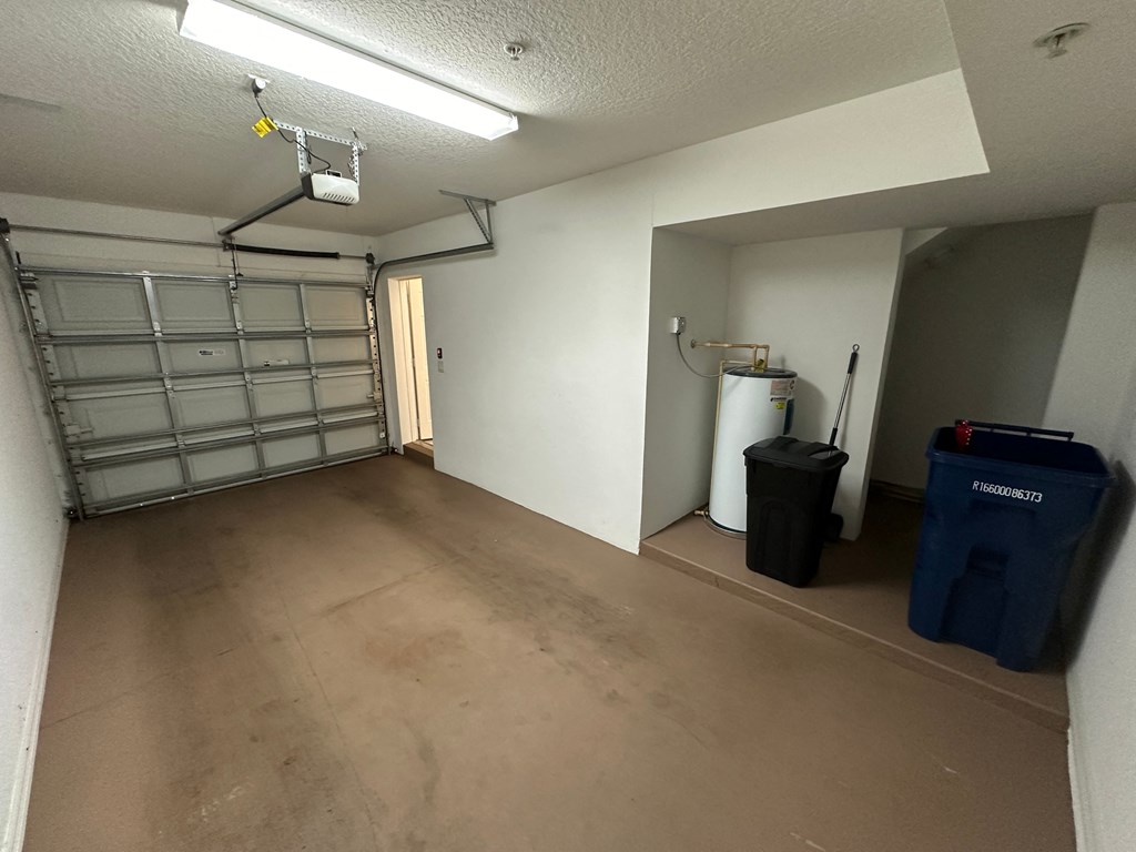 a large room with a garage door and a concrete floor