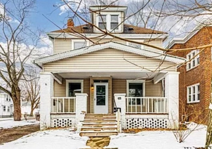 a house with a wooden bench in the snow