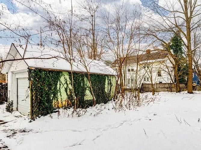 a shed and a house in the snow