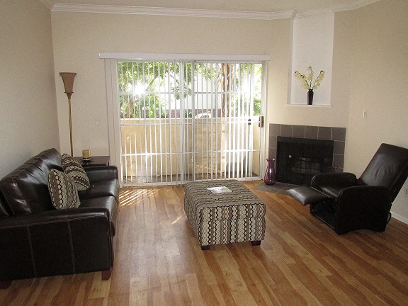 a living room with leather furniture and a fireplace