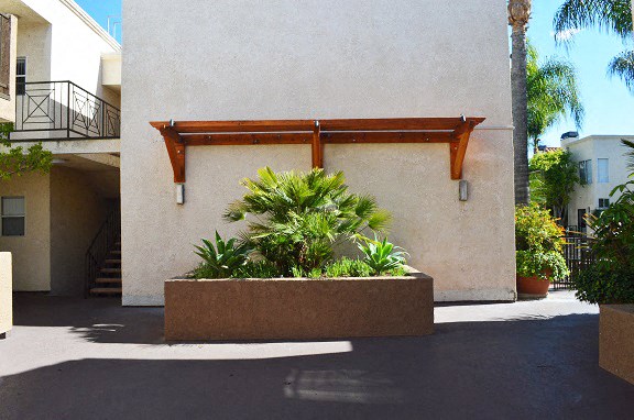 a large planter with plants in front of a building