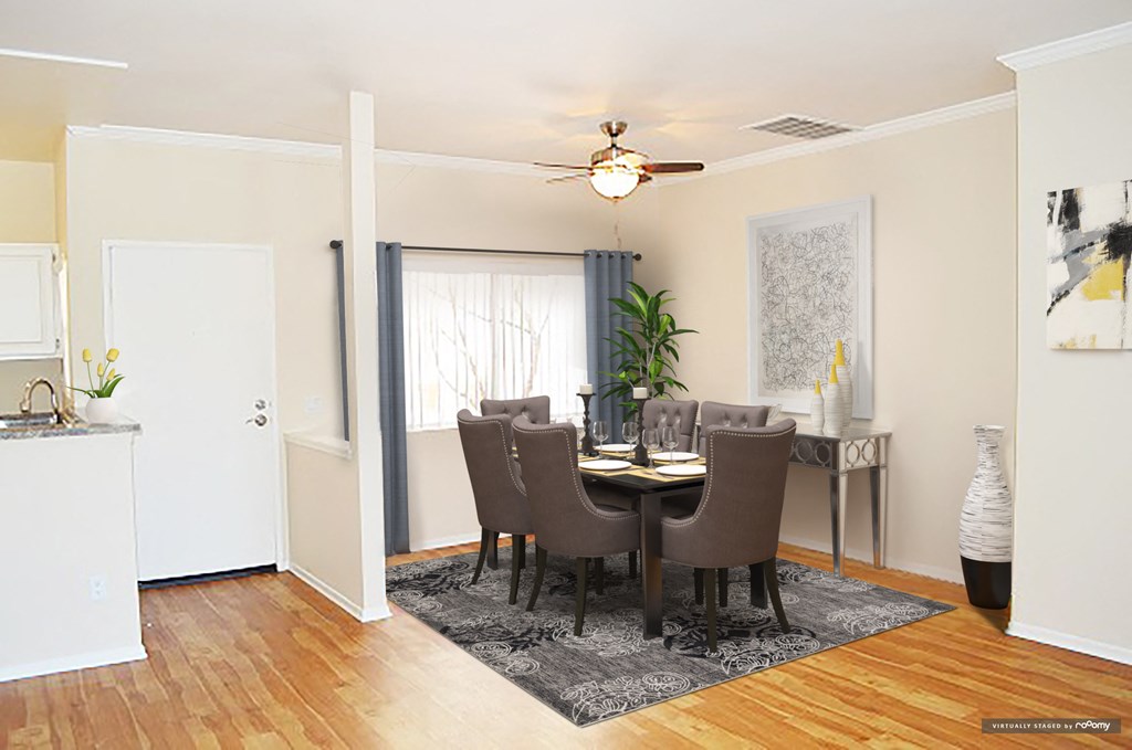 a dining room with a table and chairs and a ceiling fan