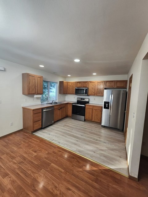 A kitchen with wooden cabinets and stainless steel appliances.