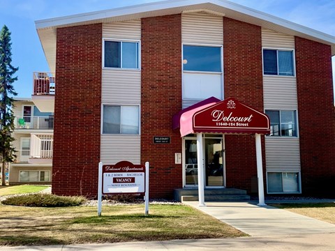 A Deloway apartment building with a sign in front.