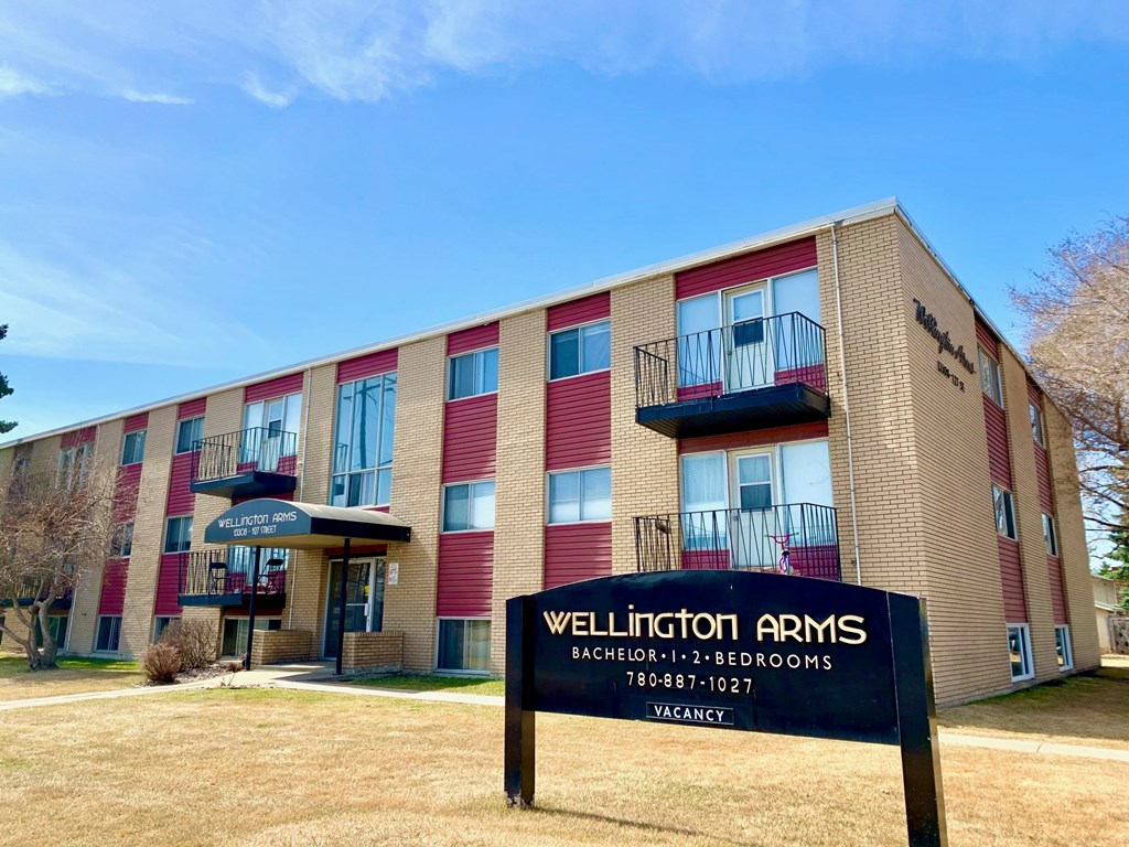 The Wellington Arms building is a multi-story residential building with a vacancy sign displayed in front.