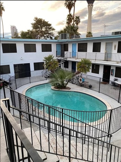 a large swimming pool in front of a building
