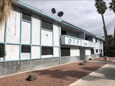 a blue and white building with two satellites on top of it