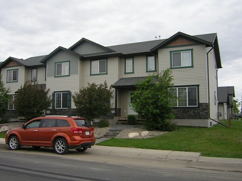 a house with a red car parked in front of it