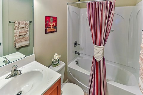 A white sink with a silver faucet in a bathroom.