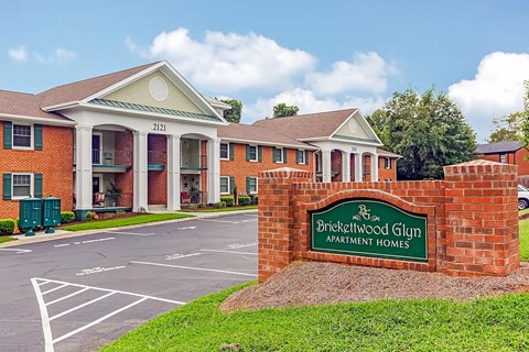The image shows a building with a sign that reads "Brickwood Glen Apartment Homes.".