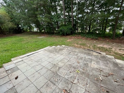 a wooden deck with trees in the background