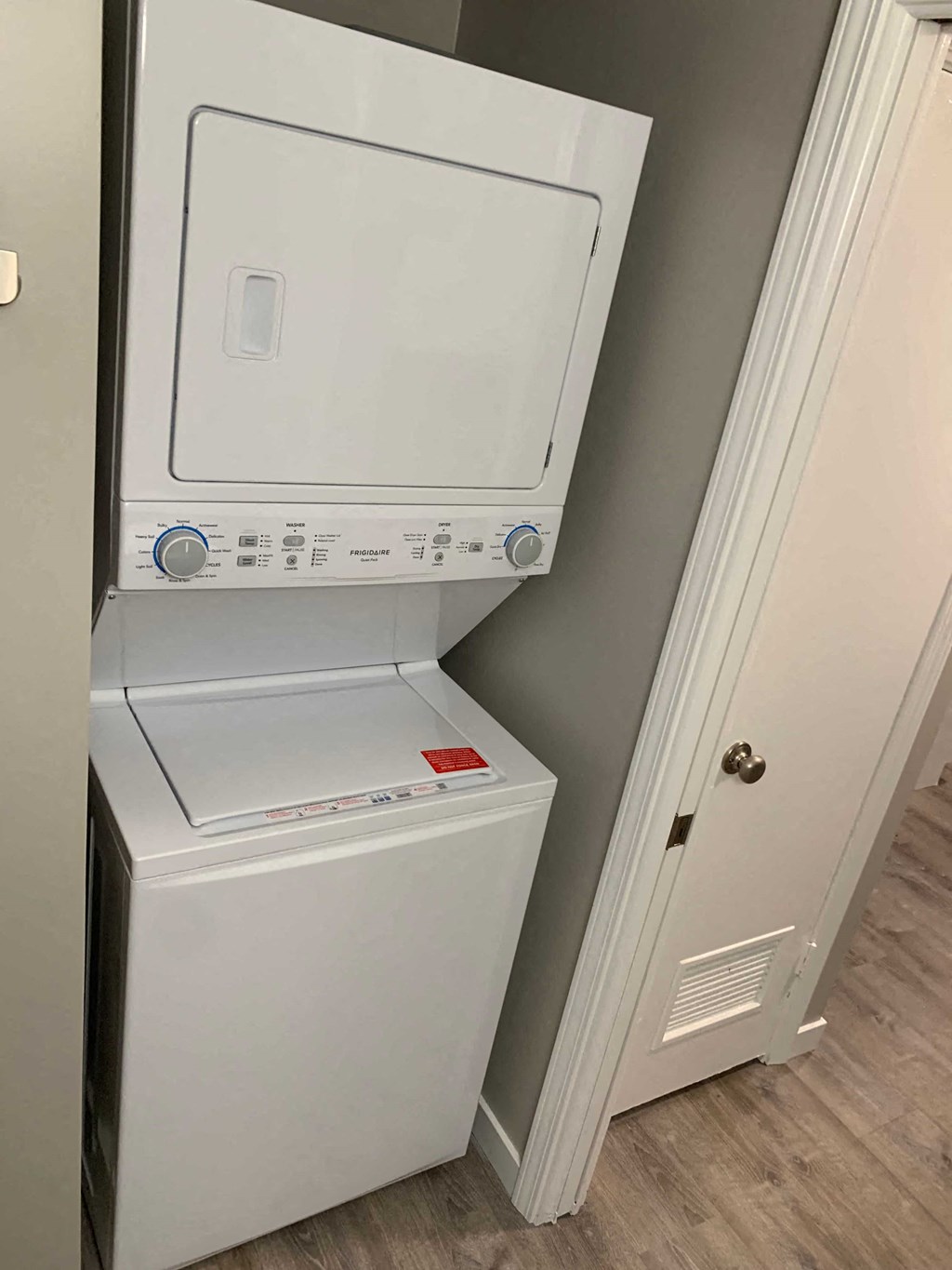 a washer and dryer in a closet next to a door