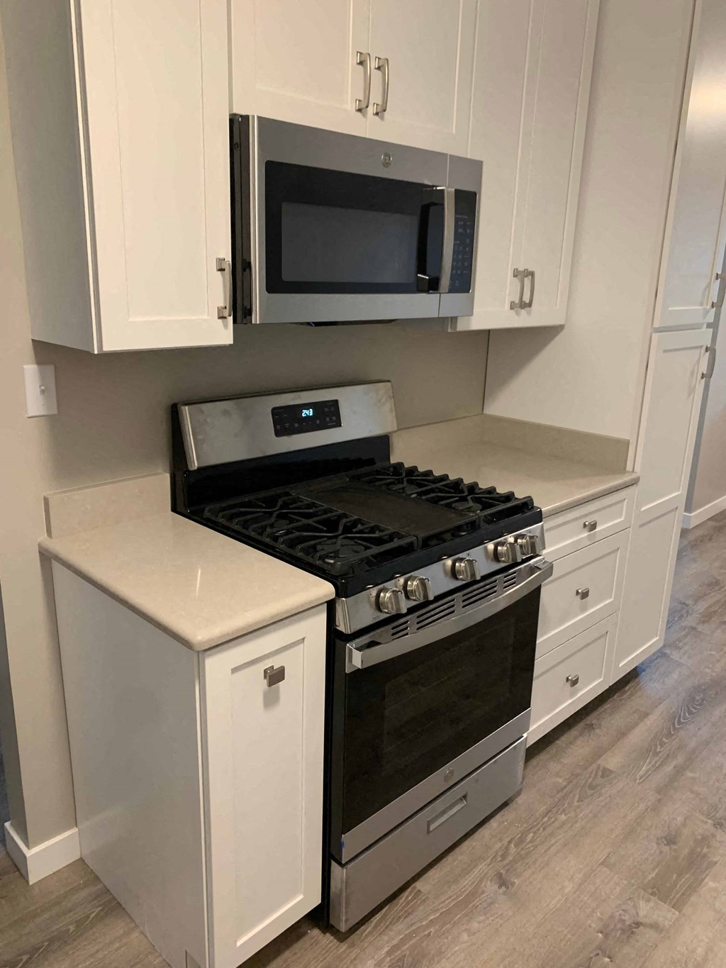 a kitchen with a stove and a microwave