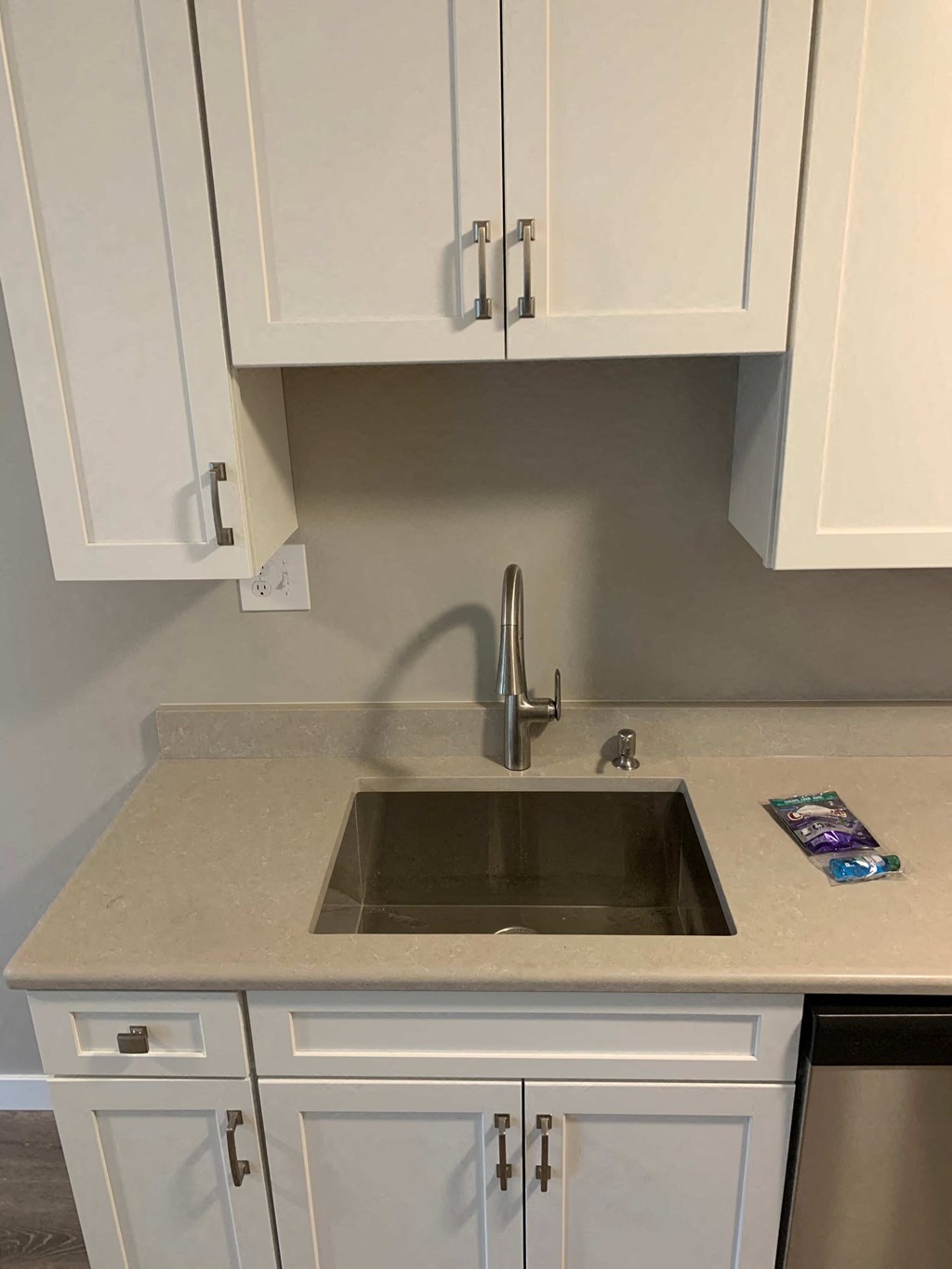 a kitchen with white cabinets and a sink