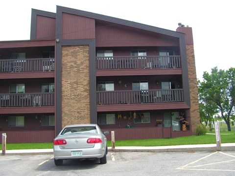 a car parked in front of an apartment building