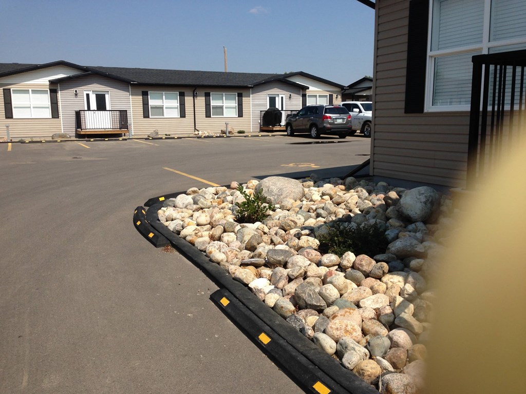 a bed of rocks in front of a house