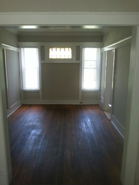 A room with wooden floors and white walls.
