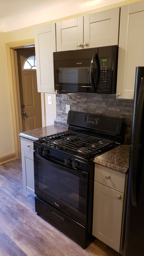 A black oven and microwave in a kitchen.