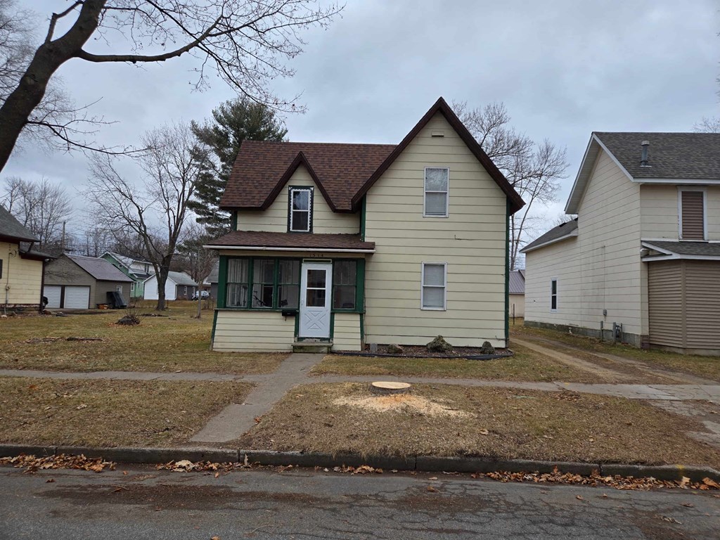 a yellow house with a yard in front of it