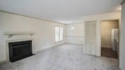 an empty living room with a fireplace