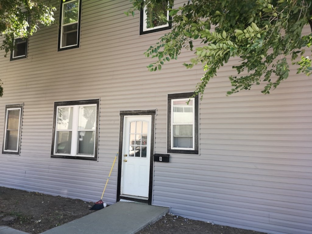 a white door on the side of a white house