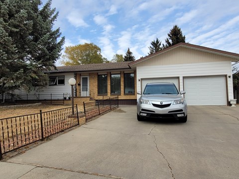 a car parked in a driveway in front of a house