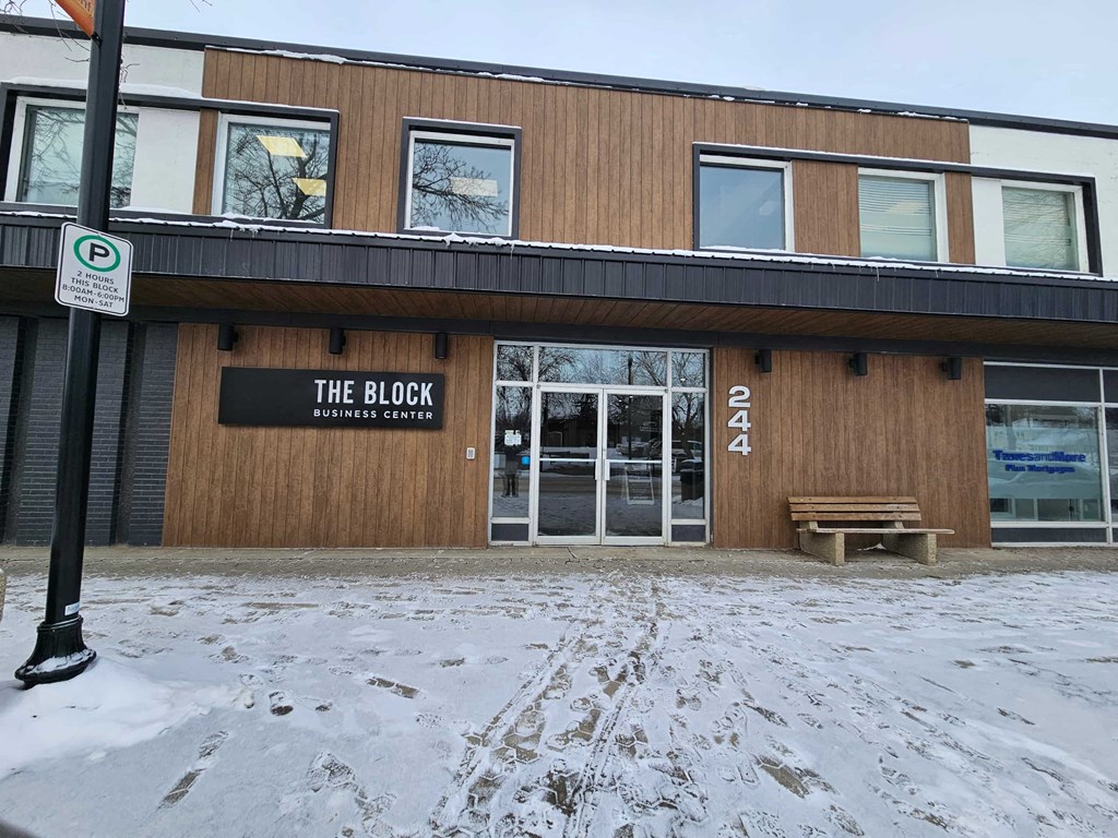 a building with a bench in the snow