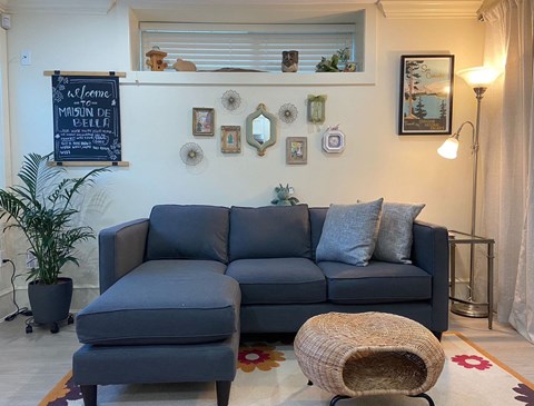 a living room with a blue couch and a chair