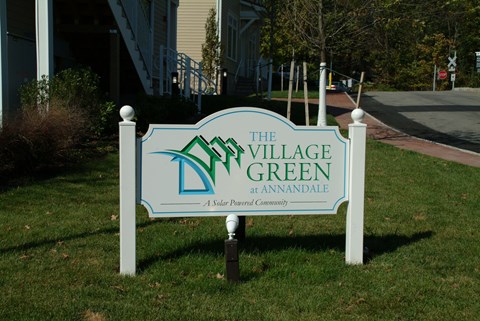 the sign in front of the village green