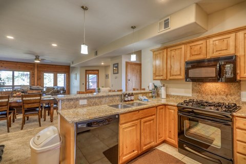 the kitchen has granite counter tops and stainless steel appliances