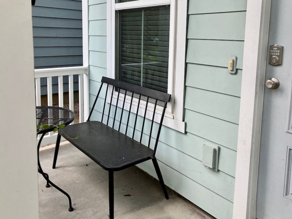 a chair sitting on a porch outside of a house
