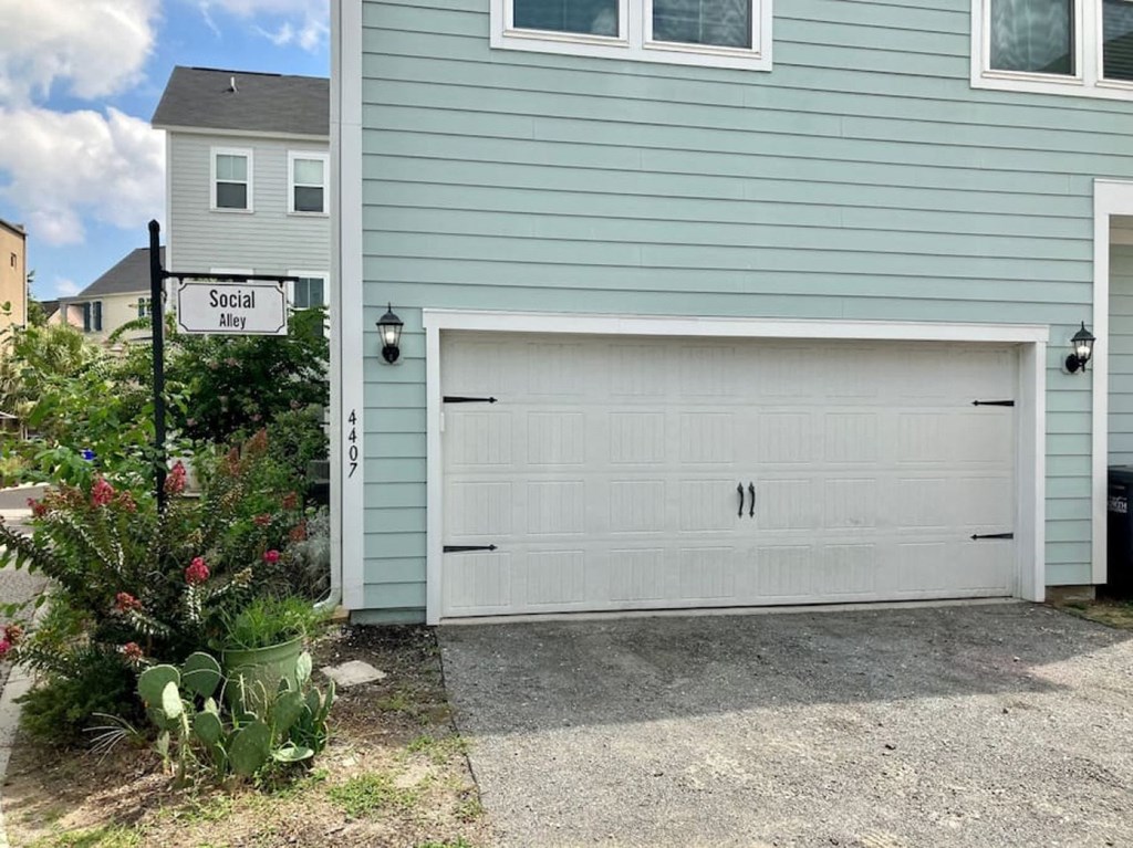 a garage door on the side of a blue house