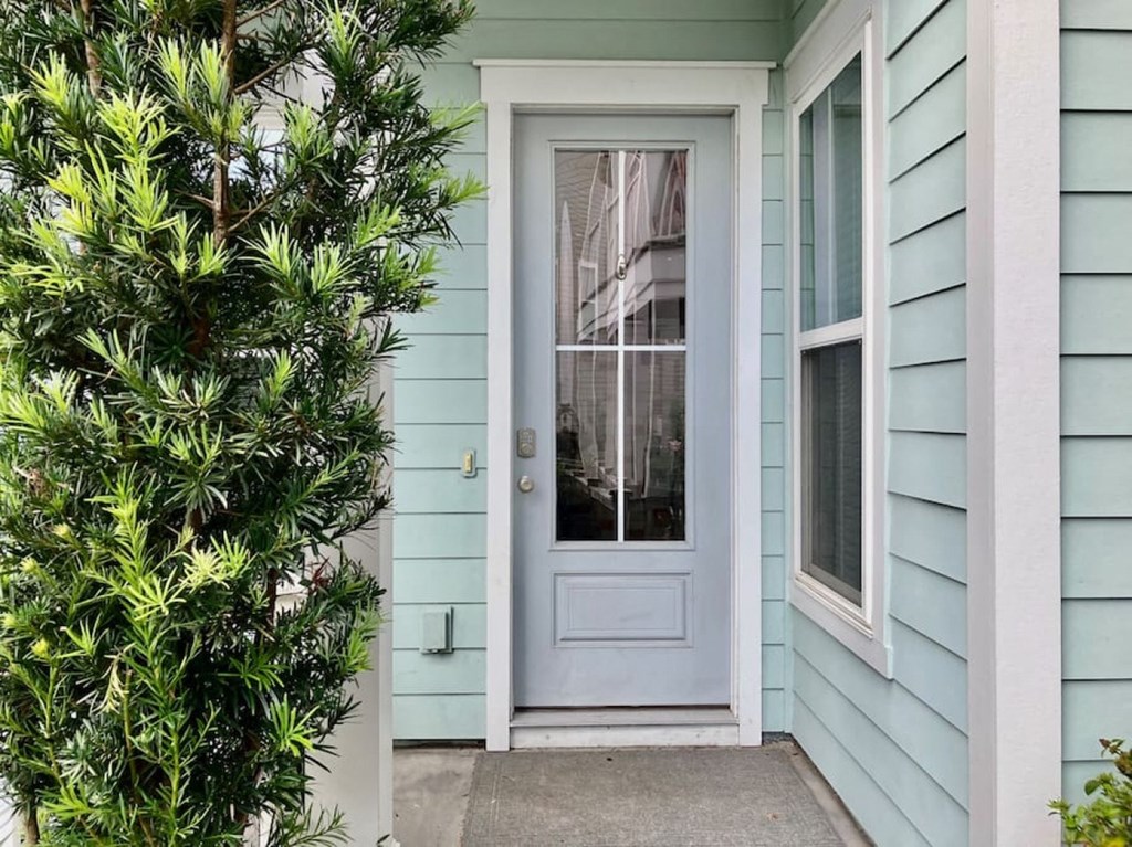 a blue house with a blue door with a glass window