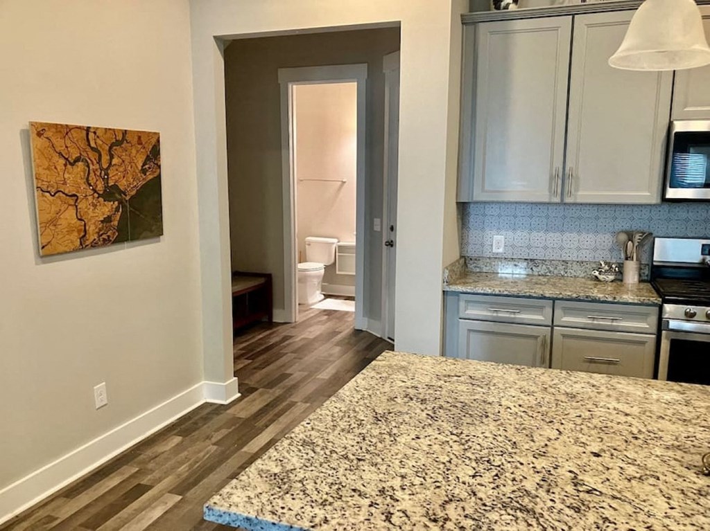 a kitchen with a counter and a door to a bathroom