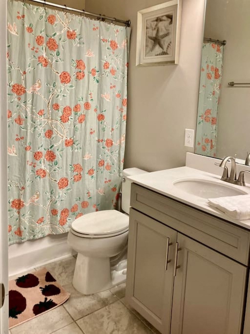 a bathroom with a toilet and a sink and a shower curtain