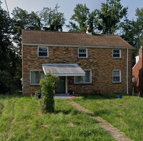 the back of a brick house with an awning on it