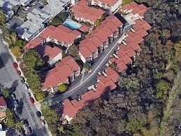 an aerial view of a building with red roofs