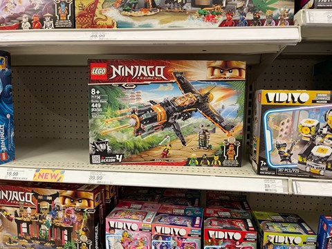 A shelf of toys including Lego and Vidiyo.