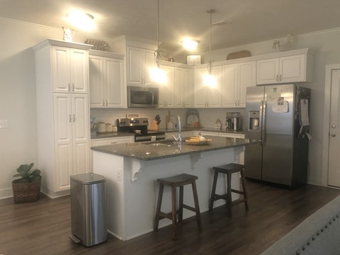 a kitchen with white cabinets and a counter top