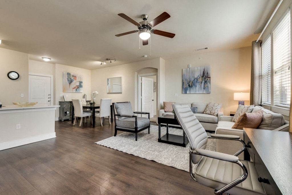 a living room and dining room with a ceiling fan