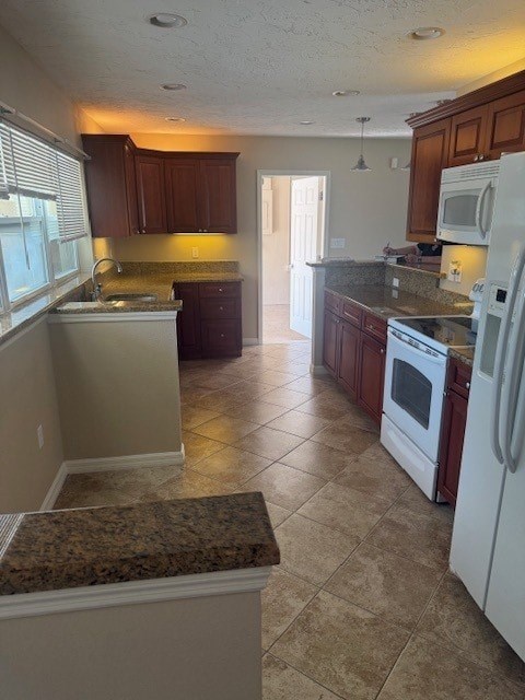 A kitchen with a white refrigerator and brown cabinets.